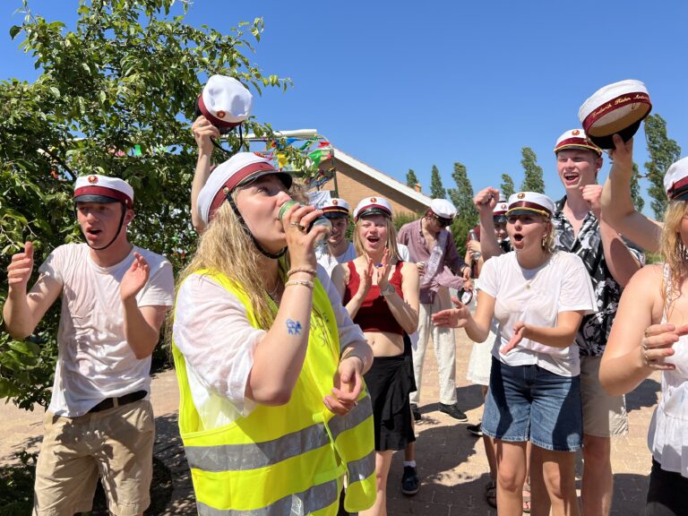 Glade studenter klar til festlig studenterkørsel i Nicedrive studentervogn, model ‘Party Non-Stop’, dekoreret med bannere og danske flag, tilgængelig til en billig pris