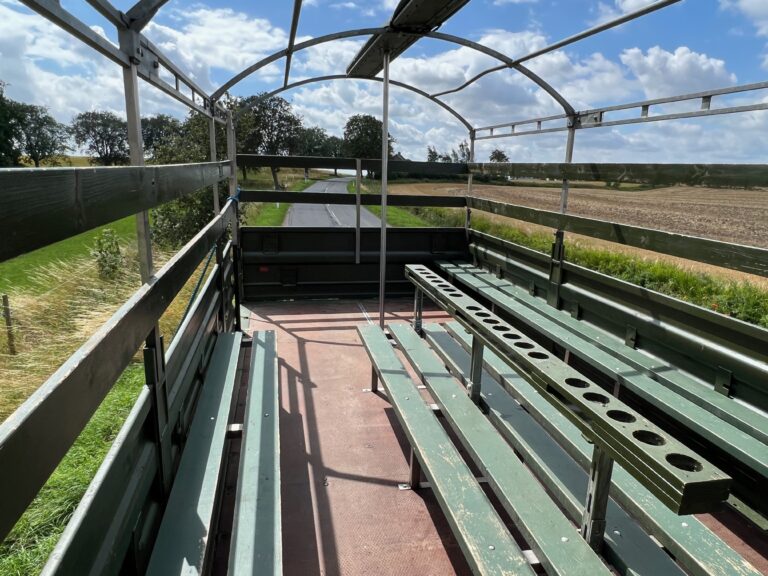 Indvendig visning af Nicedrive studentervogn, model ‘Partybomb’, til studenterkørsel, siddepladser, stripperstang, kopholder, discolys og musikanlæg, tilgængelig og ledig til en billig pris